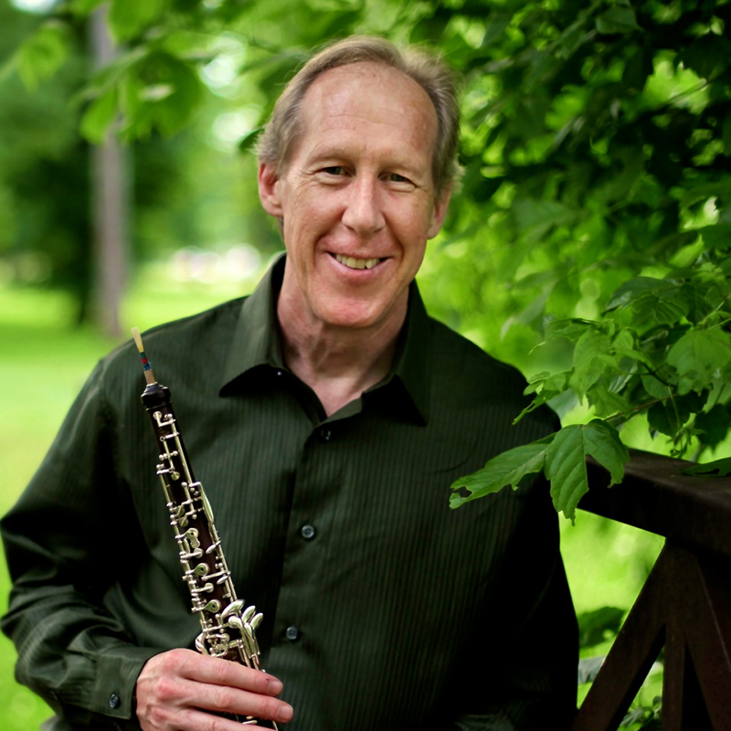  Headshot of Mark Hill and his oboe.