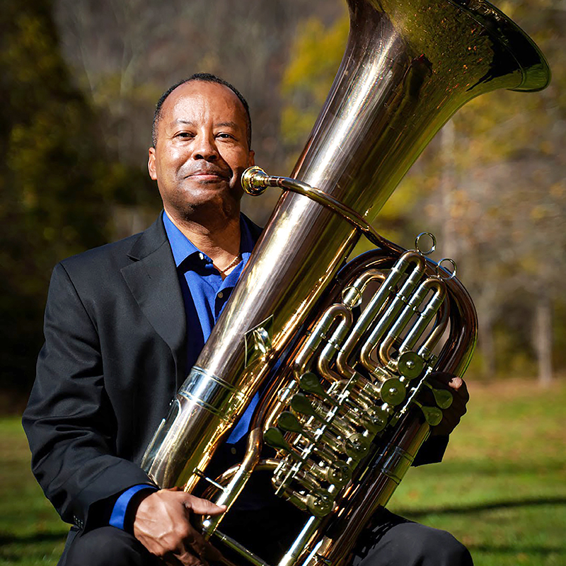  Headshot of Willie Clark holding his tuba while outside.