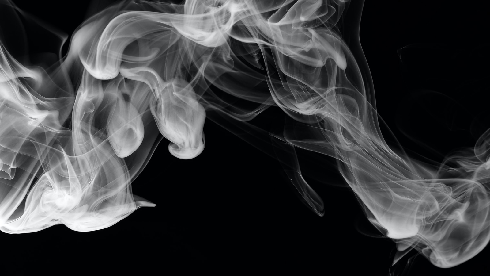 A cloud of smoke against a black background.