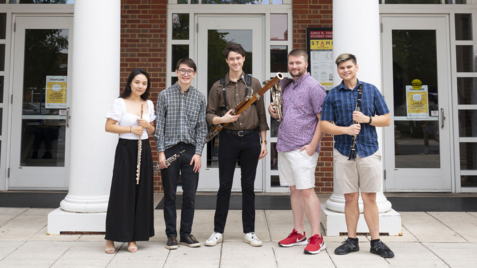 Ignis graduate fellowship woodwind quintet, from left to right: Danielle Kim with a flute, Nathaniel Wolff with an oboe, Christian Whitacre with a bassoon, Zachary Miller with a French horn, and Kyle Glasgow with a clarinet.