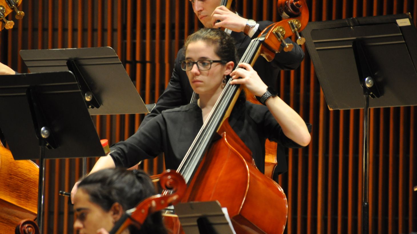 A woman plays the cello on stage.