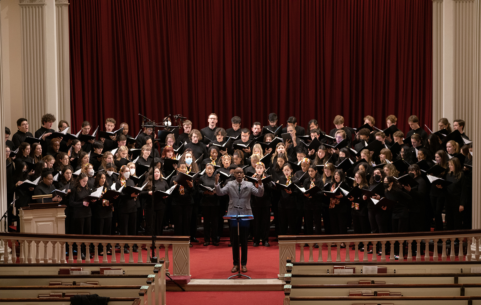 A choir performs in a chapel.