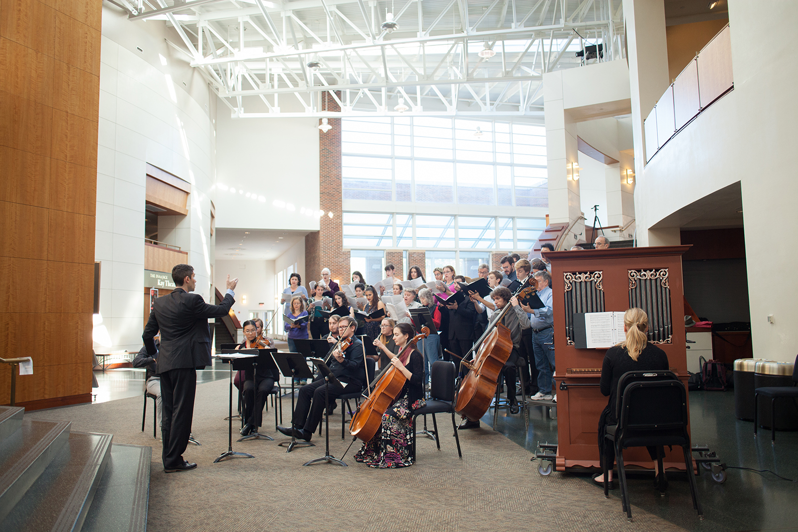 A choir and orchestral members perform in The Clarice's Grand Pavilion.