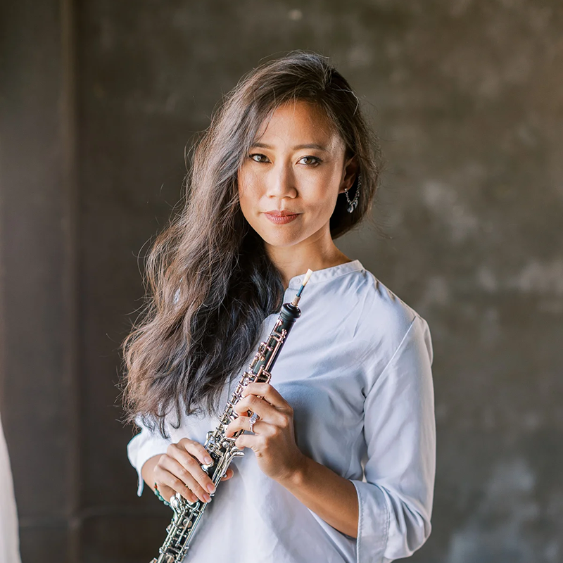 School of Music Faculty member Emily Tsai. She is wearing a blue blouse and holding her oboe.
