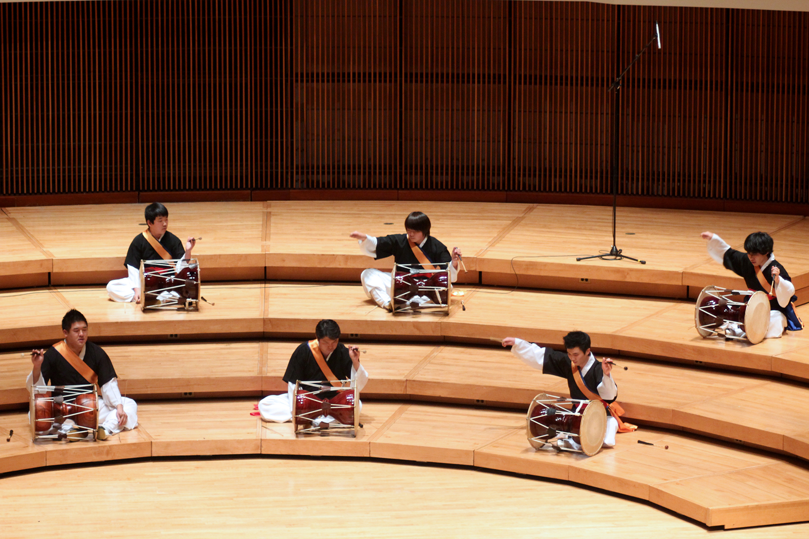 Students perform with traditional Korean drums.