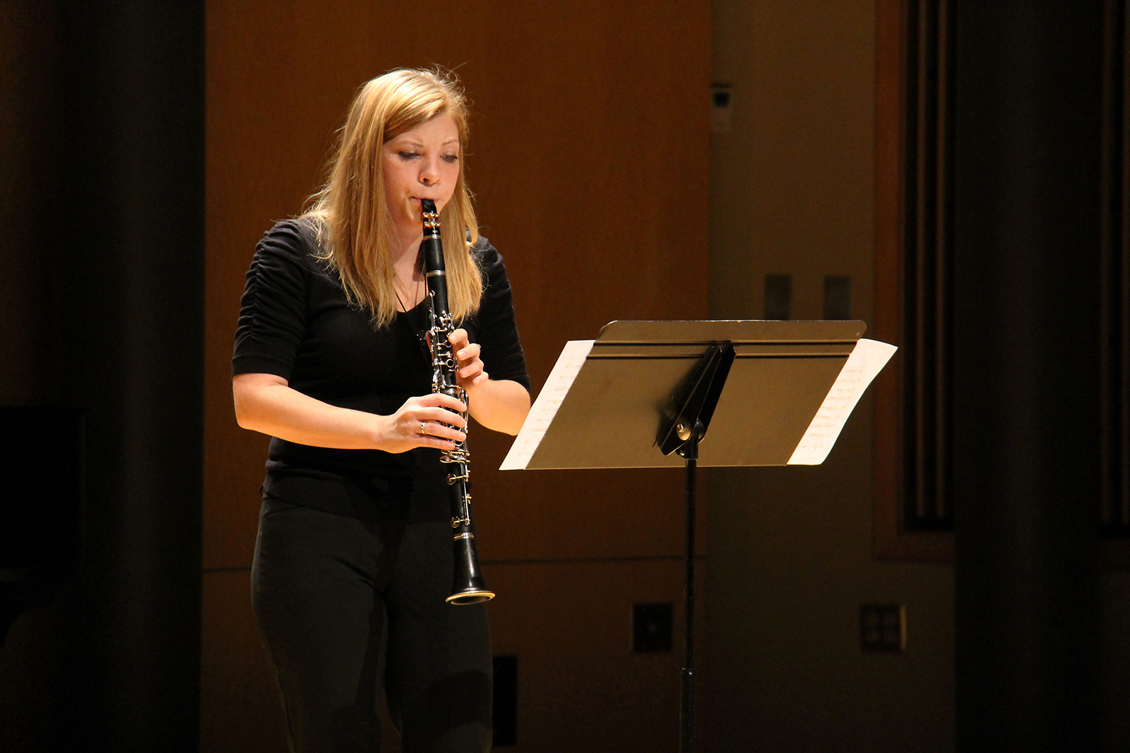 A woman plays the oboe.