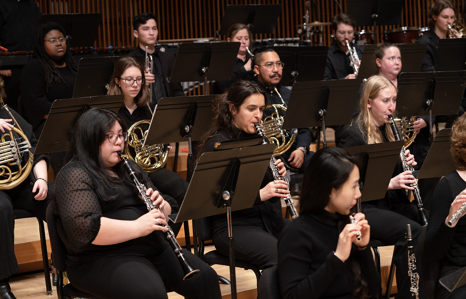 Members of the UMD Wind Orchestra perform on stage.