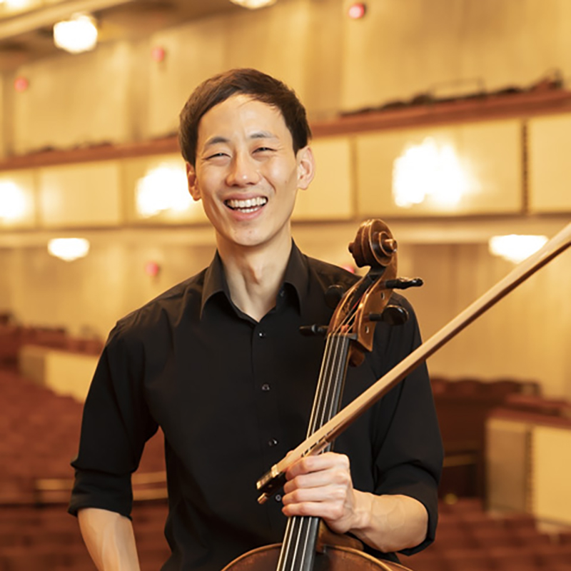 School of Music Cello lecturer Loewi Lin. He is in a black shirt holding his cello