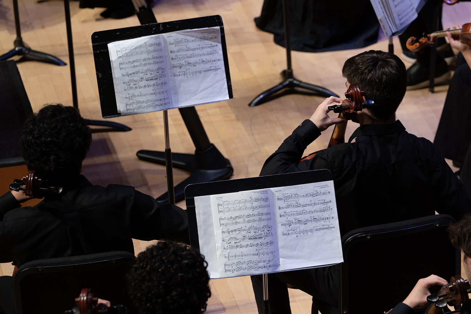 Members of the University Orchestra perform on stage.