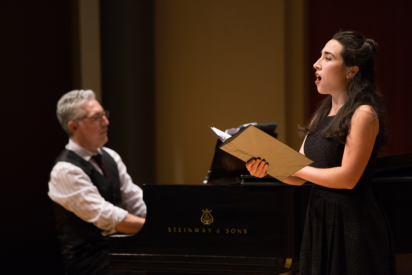 An opera singer performs to piano accompaniment. 