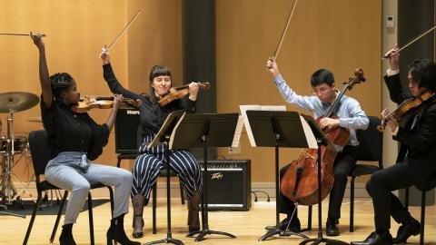  String Quartet finishes a performance on stage.