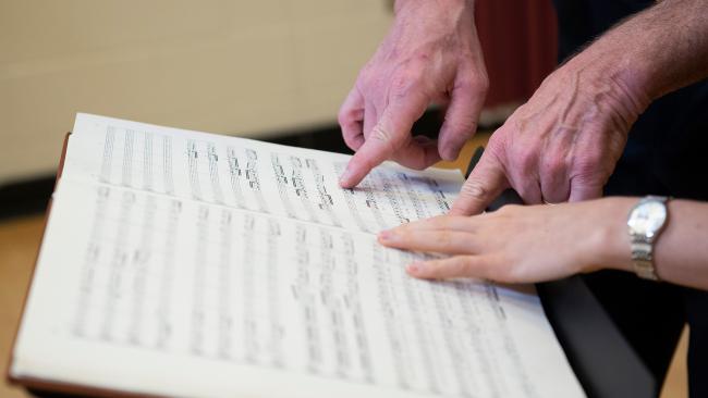 Hands pointing to a music score at the University of Maryland's School of Music at the Clarice Smith Performing Arts Center. Photo by David Andrews