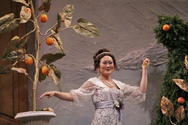 A women in an orange tree garden.